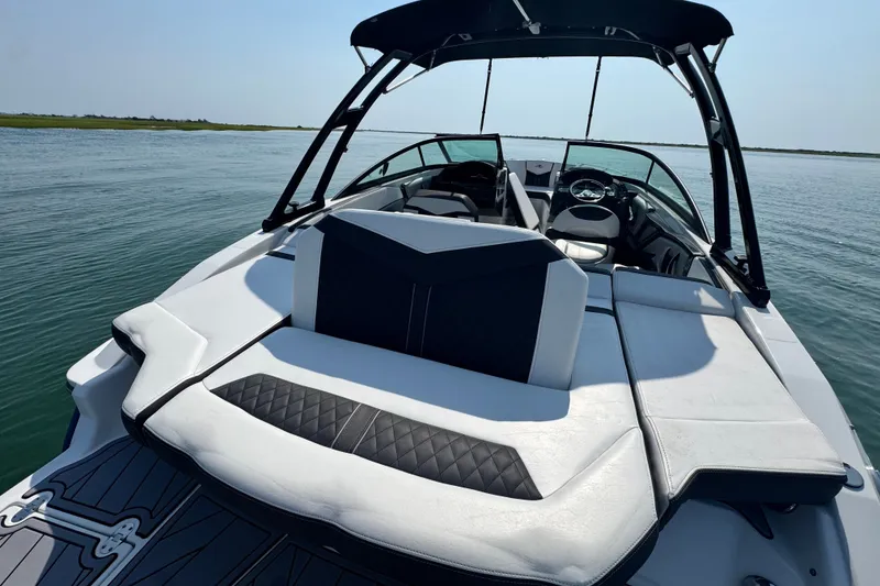 Slide: The Image of 2023 Monterey 235SS Super Sport boat on calm water, featuring sleek seating and modern design. - 10
