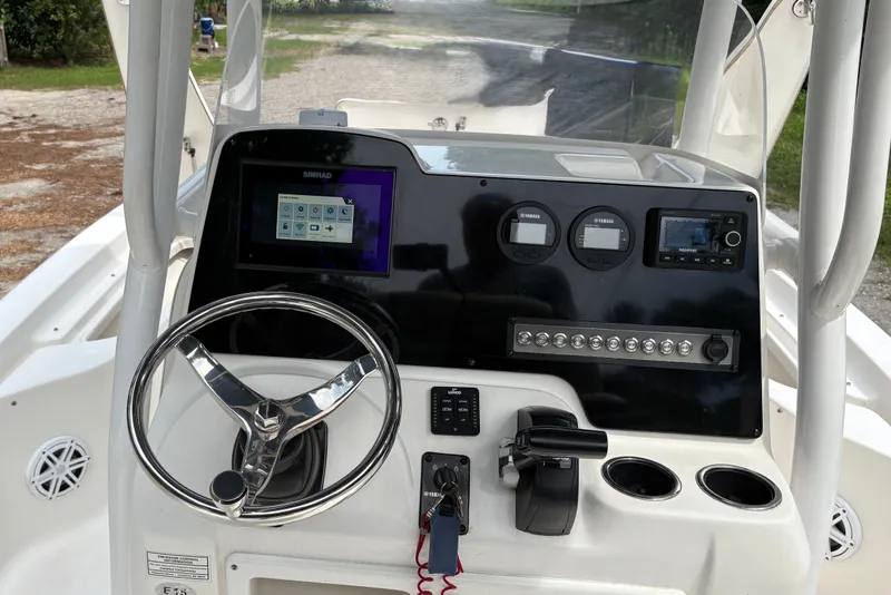 Slide: The Image of 2019 Tidewater 2200 Carolina Bay boat dashboard with steering wheel and electronic controls. - 20