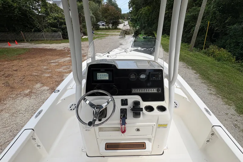 Slide: The Image of 2019 Tidewater 2200 Carolina Bay boat dashboard with steering wheel and controls. - 17
