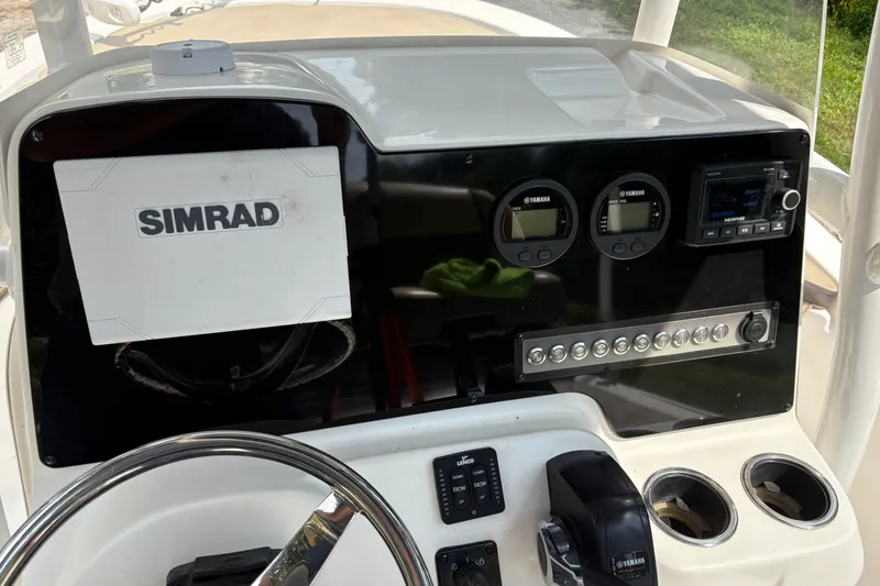 Slide: The Image of 2019 Tidewater 2200 Carolina Bay boat dashboard with Simrad navigation and Yamaha controls. - 21