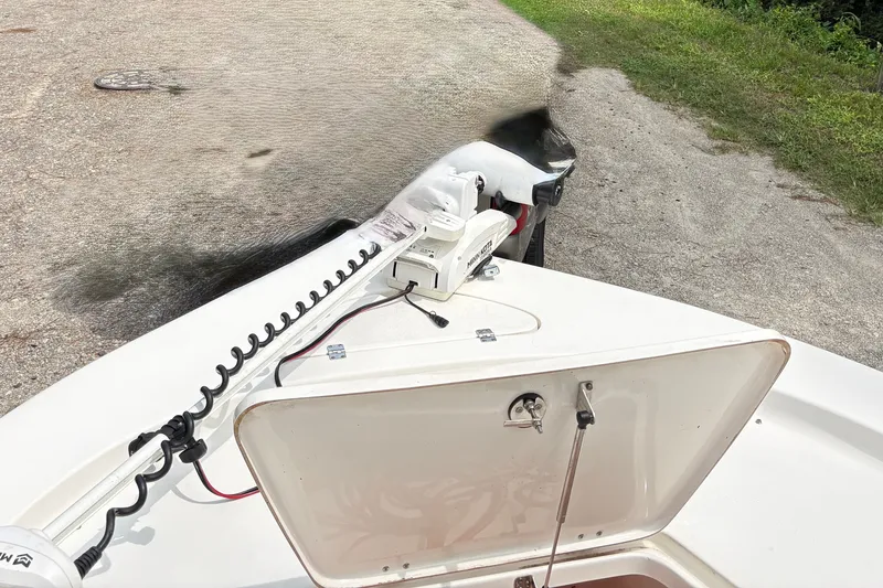 Slide: The Image of 2019 Tidewater 2200 Carolina Bay boat with open storage compartment and trolling motor. - 40