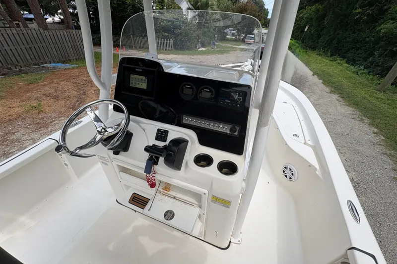 Slide: The Image of 2019 Tidewater 2200 Carolina Bay boat console with steering wheel and controls. - 18
