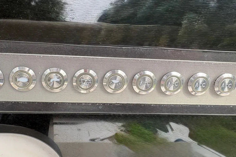 Slide: The Image of Control panel of a 2019 Tidewater 2200 Carolina Bay boat with labeled buttons. - 27