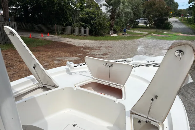 Slide: The Image of 2019 Tidewater 2200 Carolina Bay boat with open storage compartments on deck. - 39