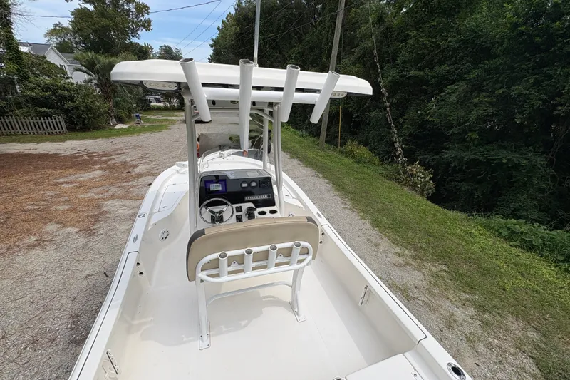 Slide: The Image of 2019 Tidewater 2200 Carolina Bay boat with center console and T-top on a gravel path. - 16