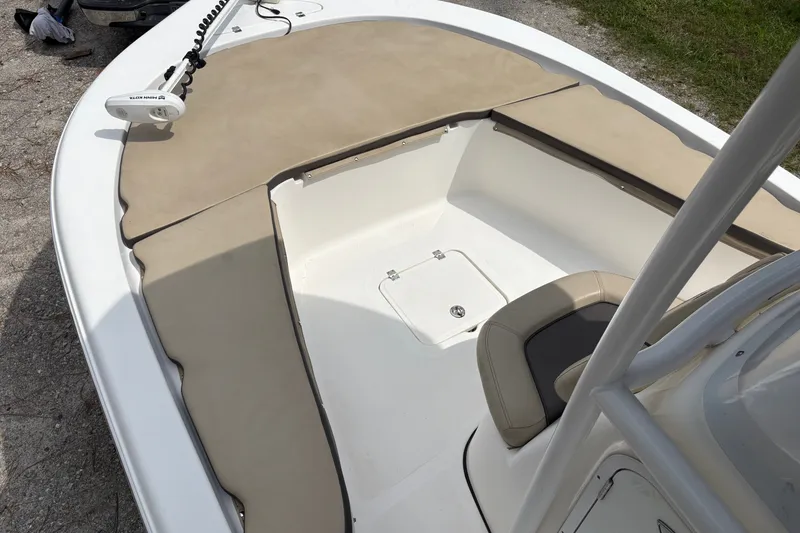 Slide: The Image of 2019 Tidewater 2200 Carolina Bay boat interior with tan seating and Minn Kota trolling motor. - 14