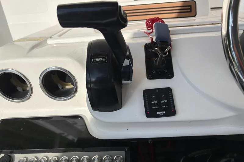 Slide: The Image of The image shows the helm of a 2019 Tidewater 2200 Carolina Bay boat with throttle and instruments. - 22