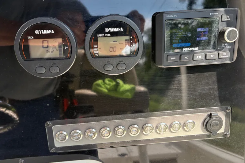 Slide: The Image of Dashboard of a 2019 Tidewater 2200 Carolina Bay boat with Yamaha gauges and Memphis audio system. - 26