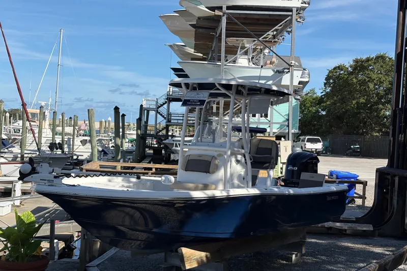 Slide: The Image of 2019 Tidewater 2200 Carolina Bay boat docked at a marina under clear blue skies. - 12