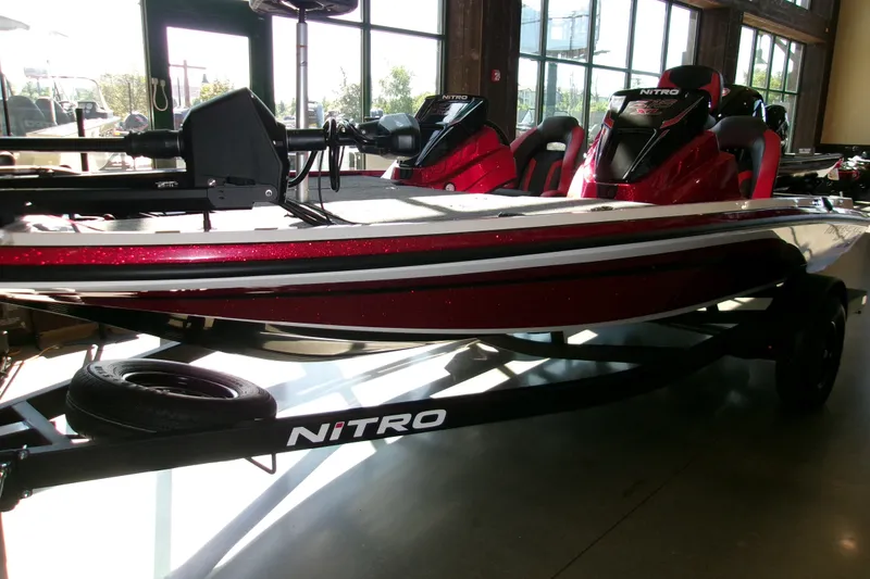 The Image of 2027 Nitro Z18 XL Pro boat in showroom, featuring sleek red design and modern features. - 0