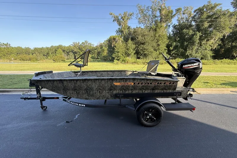 The Image of 2027 Tracker Grizzly 1553 Timber boat with Mercury engine on trailer, outdoors. - 0
