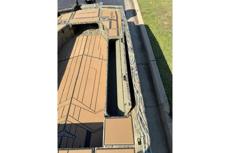 Slide: The Image of 2027 Tracker Grizzly 1756 T Marsh boat with open storage compartment, camo design. - 15