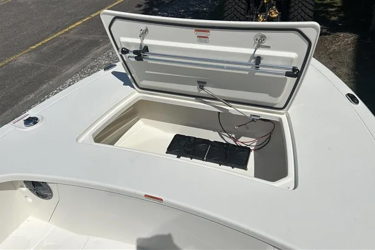 Slide: The Image of 2026 Mako 18 Pro Skiff boat with open storage compartment and visible wiring. - 4