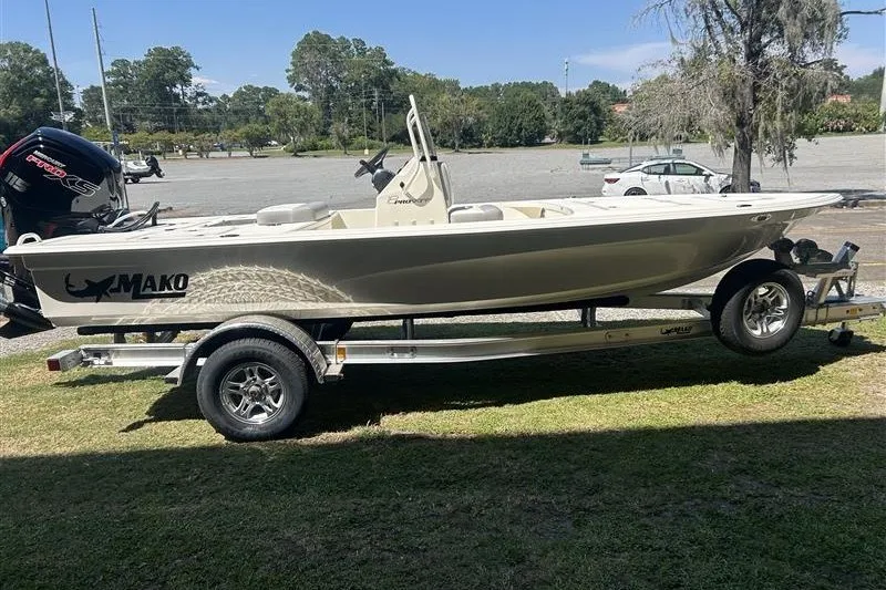 The Image of 2026 Mako 18 Pro Skiff boat on trailer, parked on grass. - 0