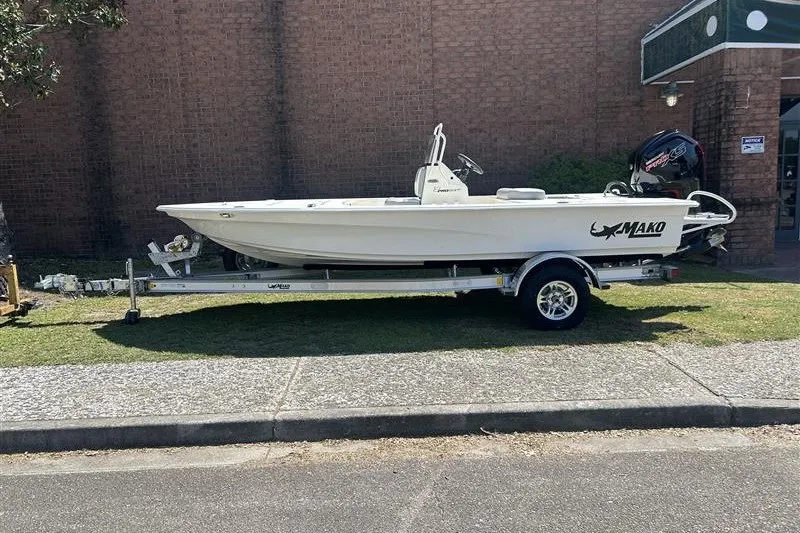 Slide: The Image of 2026 Mako 18 Pro Skiff boat on trailer, parked outdoors. - 1