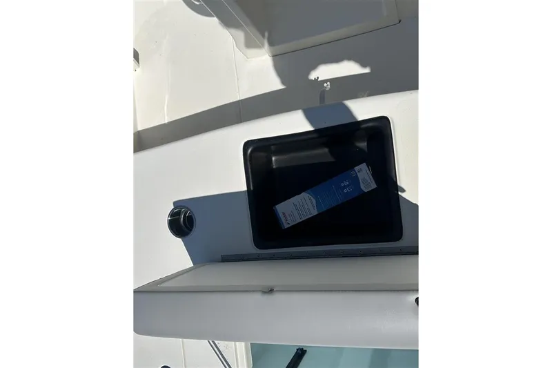 Slide: The Image of Open storage compartment on 2026 Mako 18 Pro Skiff boat deck. - 9