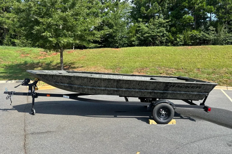 The Image of 2027 Tracker Grizzly 1648 Utility boat on trailer in parking lot. - 0