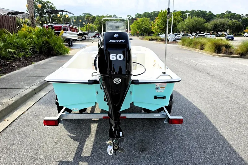 Slide: The Image of 2026 Mako Pro Skiff 15 CC with Mercury 60 engine on trailer in parking lot. - 4