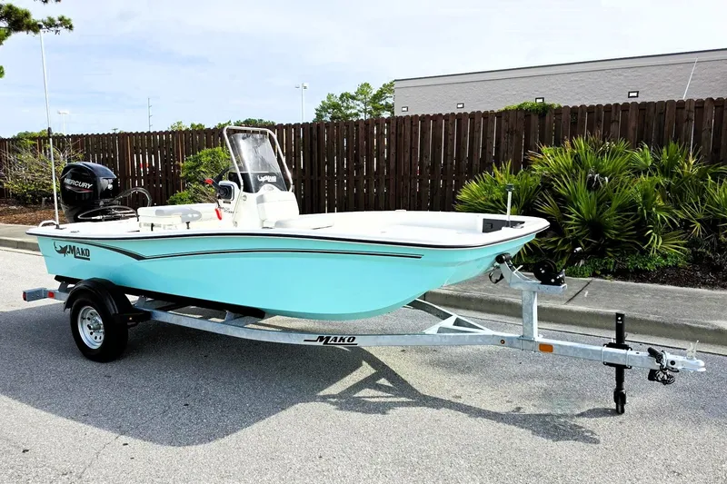 Slide: The Image of 2026 Mako Pro Skiff 15 CC boat on trailer, parked outdoors. - 5