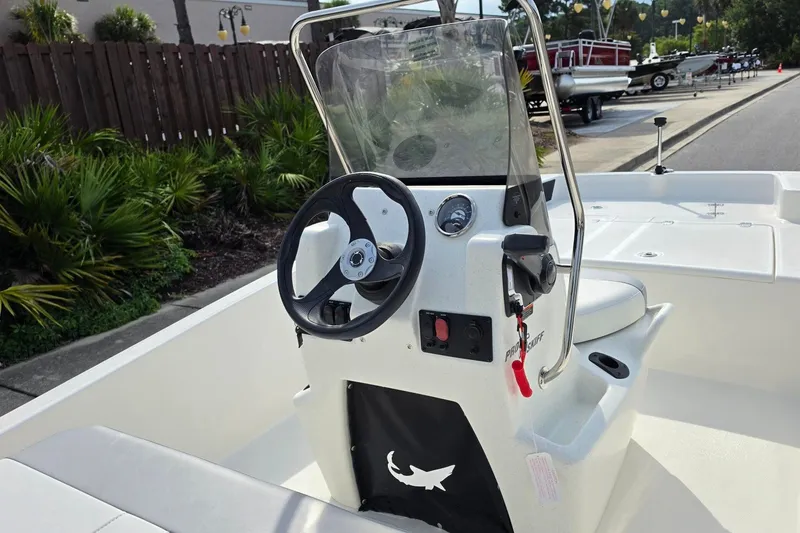 Slide: The Image of 2026 Mako Pro Skiff 15 CC boat interior with steering console and seating. - 14