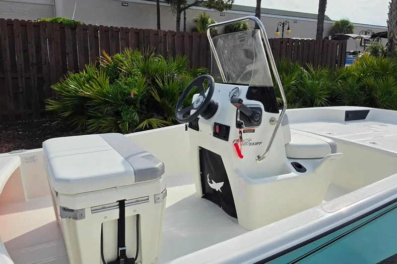 Slide: The Image of 2026 Mako Pro Skiff 15 CC boat interior with steering console and seating. - 15