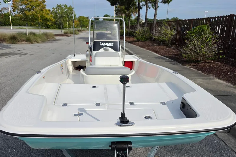 Slide: The Image of 2026 Mako Pro Skiff 15 CC boat on a trailer, parked outdoors. - 8