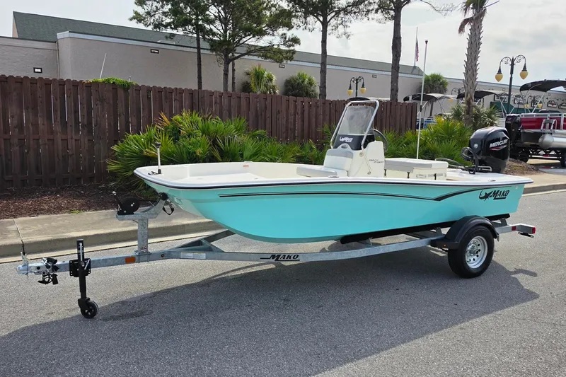 Slide: The Image of 2026 Mako Pro Skiff 15 CC boat on trailer, parked outdoors. - 11