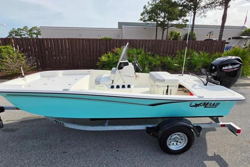 Slide: The Image of 2026 Mako Pro Skiff 15 CC boat on trailer, featuring a Mercury outboard motor. - 9