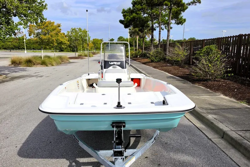 Slide: The Image of 2026 Mako Pro Skiff 15 CC boat on trailer in a parking lot. - 7