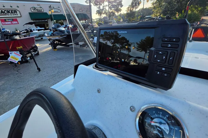 Slide: The Image of 2026 Mako Pro Skiff 15 CC dashboard with Garmin GPS at a boat dealership. - 19