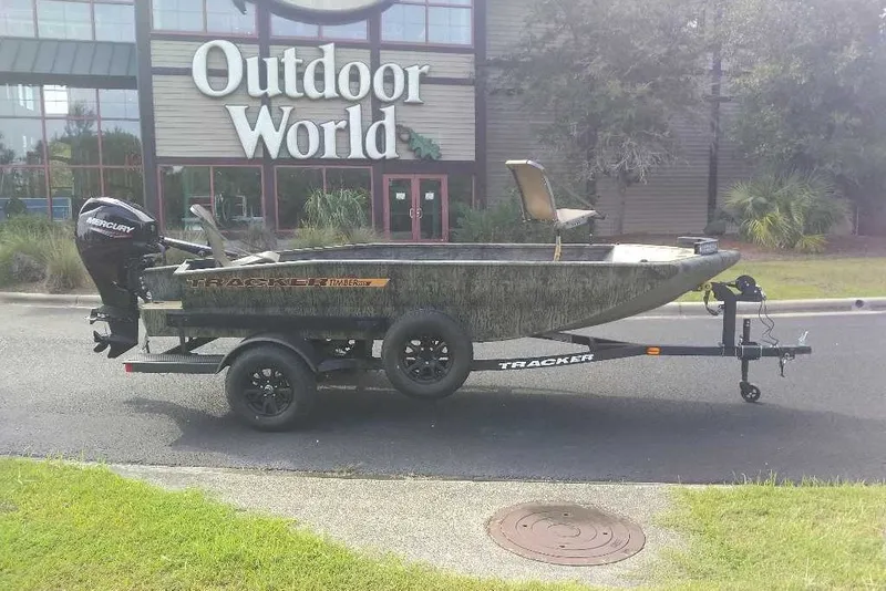 The Image of 2027 Tracker Grizzly 1553 Timber boat on trailer outside Outdoor World store. - 0