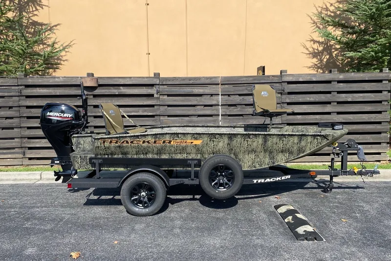 The Image of 2027 Tracker Grizzly 1553 Timber boat with Mercury engine on trailer, outdoors. - 0