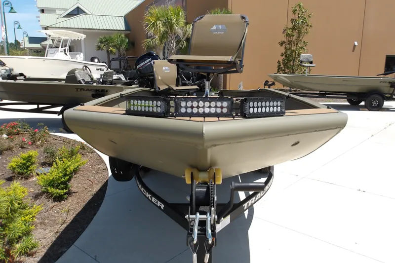 Slide: The Image of 2027 Tracker Grizzly 1553 Timber boat with LED lights on display outdoors. - 17