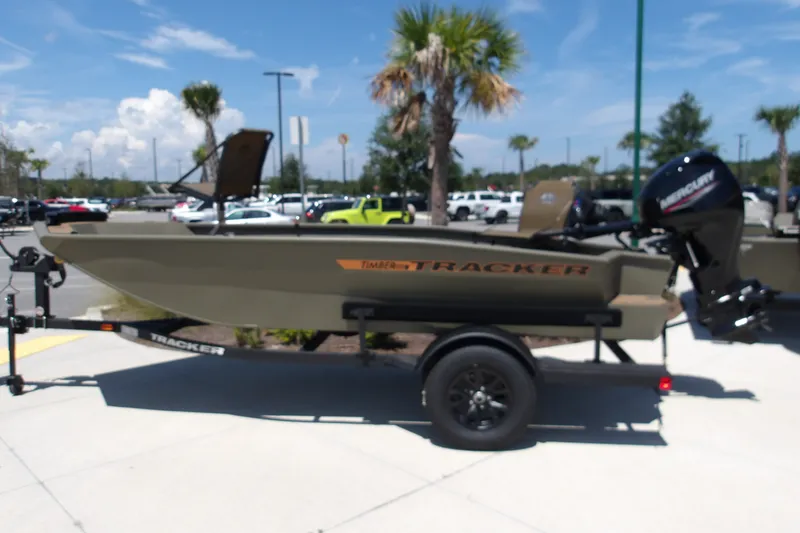 The Image of 2027 Tracker Grizzly 1553 Timber boat on trailer, parked outdoors. - 2