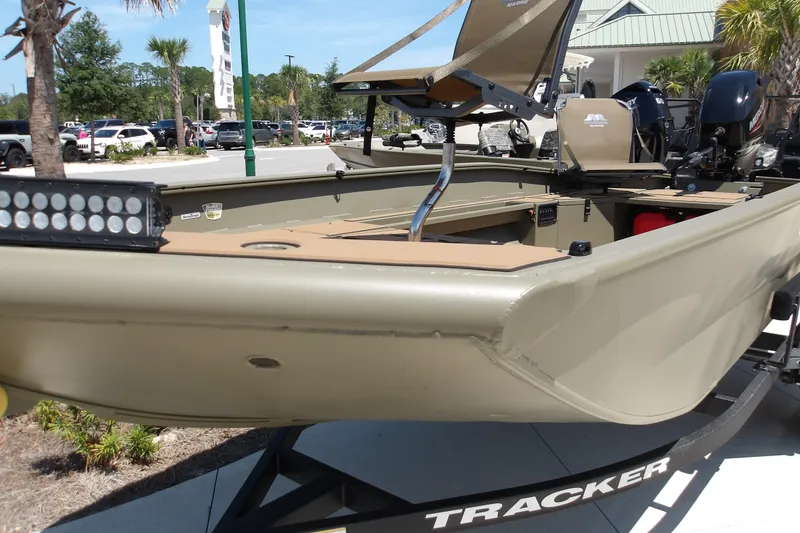 Slide: The Image of 2027 Tracker Grizzly 1553 Timber boat on display, featuring a light bar and seating. - 18