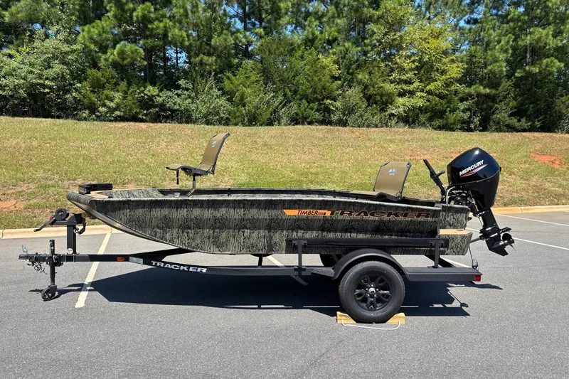The Image of 2027 Tracker Grizzly 1553 Timber boat on trailer, parked outdoors. - 0