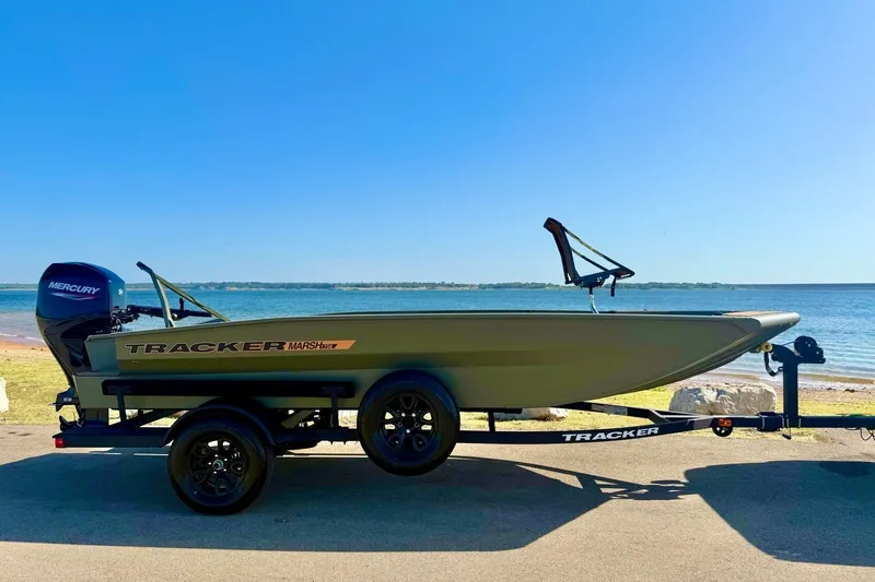 Slide: The Image of 2027 Tracker Grizzly 1756 T Marsh boat on trailer by the lake. - 69