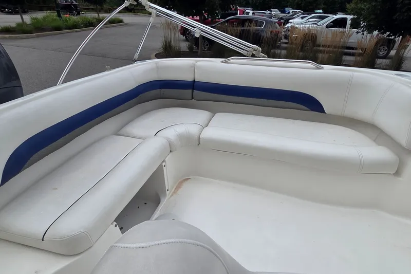 Slide: The Image of Interior seating of a 2011 Hurricane SunDeck Sport 188 OB boat, featuring white and blue upholstery. - 6