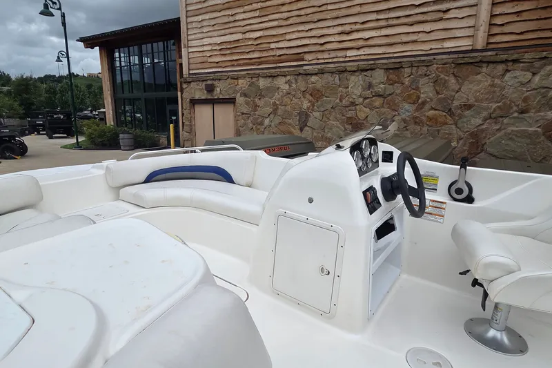 Slide: The Image of 2011 Hurricane SunDeck Sport 188 OB boat interior with white seating and steering console. - 4