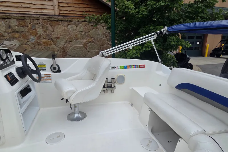 Slide: The Image of 2011 Hurricane SunDeck Sport 188 OB boat interior with white seating and steering console. - 5
