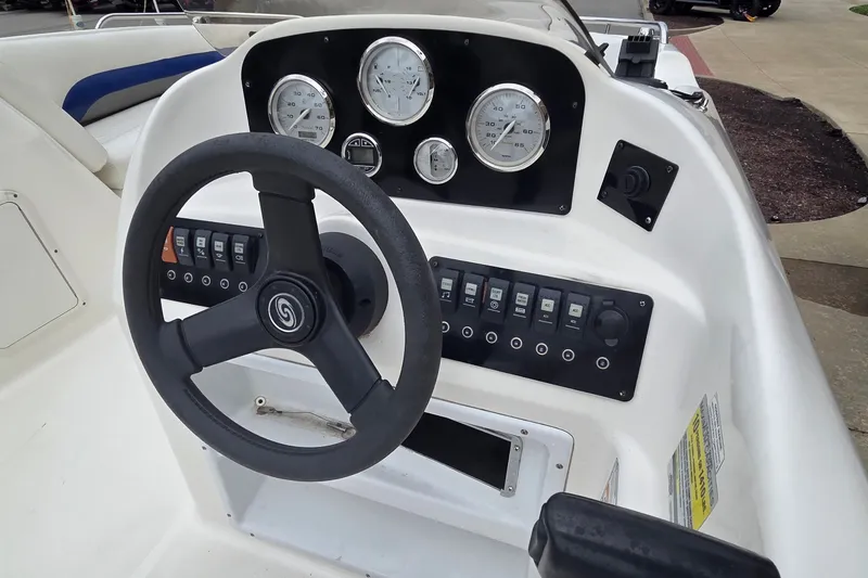 Slide: The Image of 2011 Hurricane SunDeck Sport 188 OB boat dashboard with steering wheel and gauges. - 1