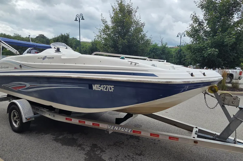 Slide: The Image of 2011 Hurricane SunDeck Sport 188 OB boat on trailer, parked outdoors. - 7