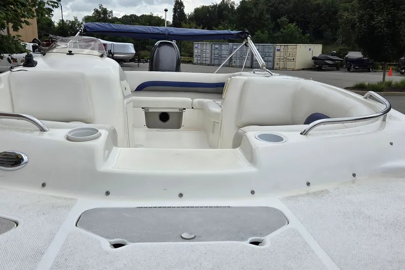 Slide: The Image of 2011 Hurricane SunDeck Sport 188 OB boat interior with white seating and cup holders. - 3