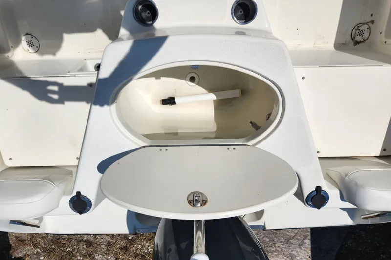 Slide: The Image of 2004 Hydra-Sports Lightning 202 DC boat interior with storage compartment and seating. - 17