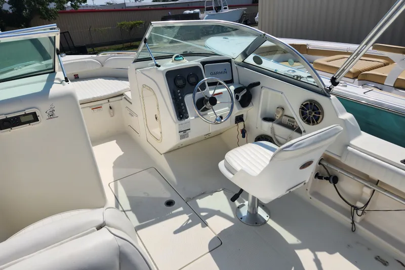 Slide: The Image of 2004 Hydra-Sports Lightning 202 DC boat interior with steering wheel and Garmin navigation system. - 6
