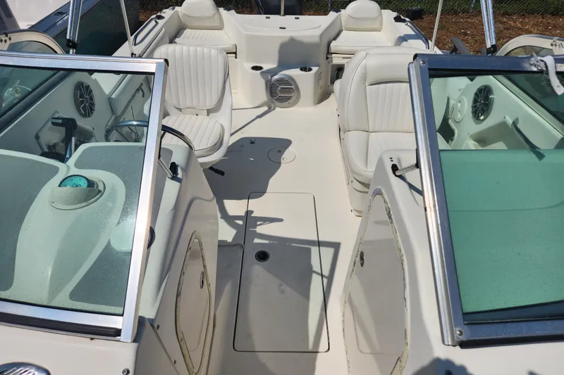 Slide: The Image of 2004 Hydra-Sports Lightning 202 DC boat interior with white seating and dual consoles. - 13
