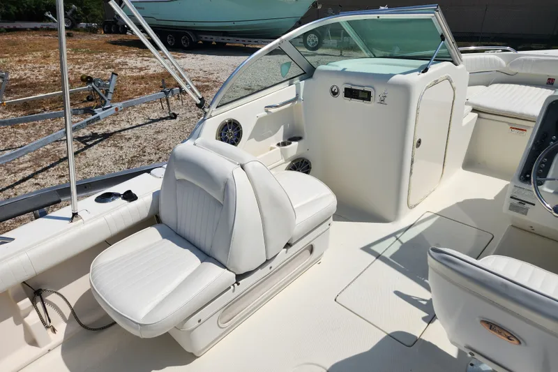 Slide: The Image of 2004 Hydra-Sports Lightning 202 DC boat interior with white seating and dashboard. - 9