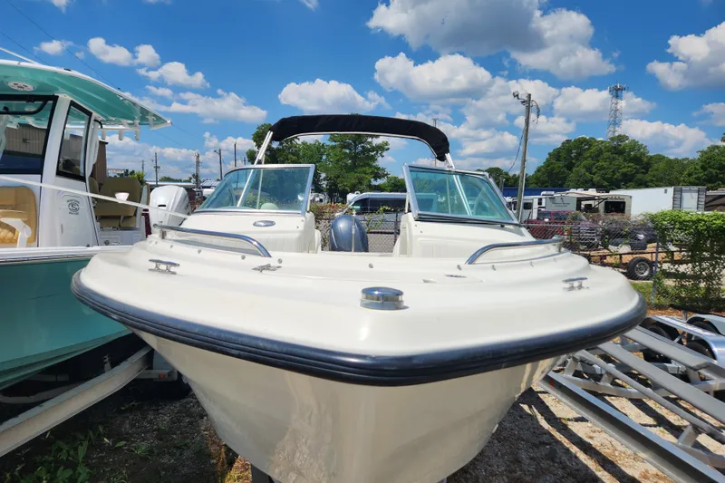 Slide: The Image of 2004 Hydra-Sports Lightning 202 DC boat displayed outdoors under a blue sky. - 2