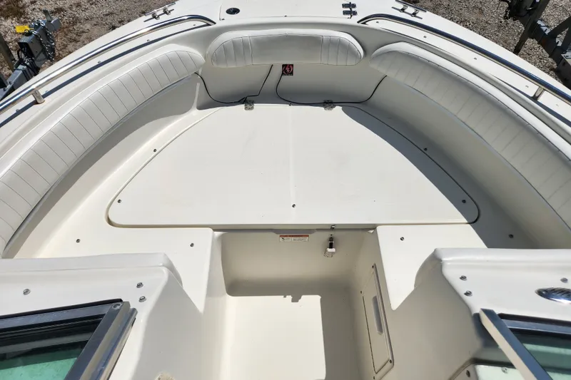 Slide: The Image of 2004 Hydra-Sports Lightning 202 DC boat interior with white seating and storage area. - 11