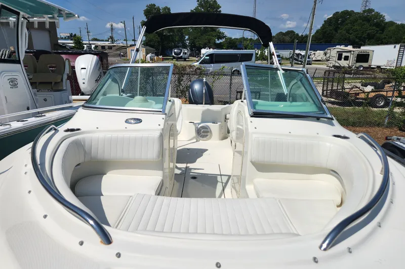 Slide: The Image of 2004 Hydra-Sports Lightning 202 DC boat with white seating and windshield, docked outdoors. - 10